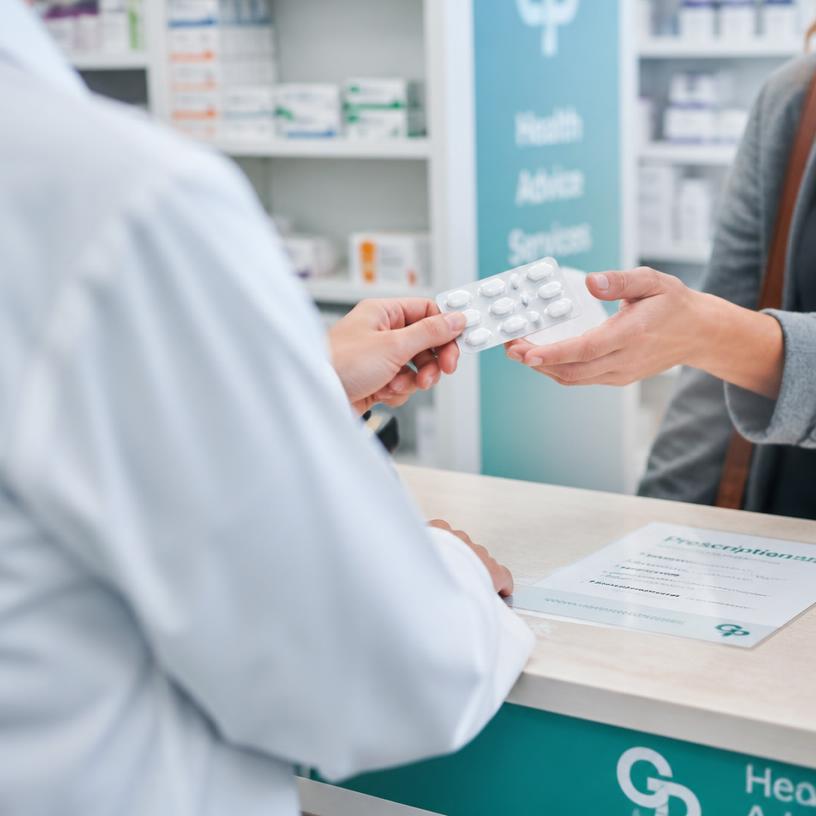 Illustration of a pharmacist handing oral contraception to a patient